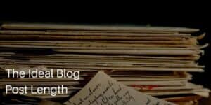 The Ideal Blog Post Length with stack of papers with writing on them in background.