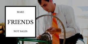 Build Lasting Client Relationships: Make Friends Not Sales. Picture: Business man in suit with jacket off fixing his bicycle tire.|Turned On Light Bulb Illustration