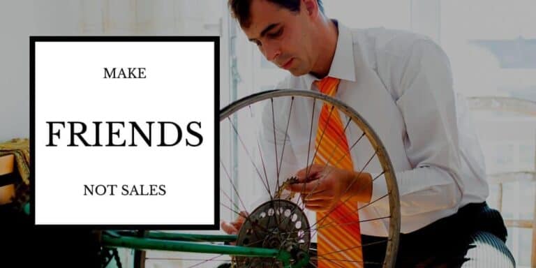 Build Lasting Client Relationships: Make Friends Not Sales. Picture: Business man in suit with jacket off fixing his bicycle tire.|Turned On Light Bulb Illustration