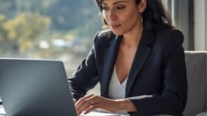 Placer County business owner reviewing a custom website design on a laptop in a modern office.